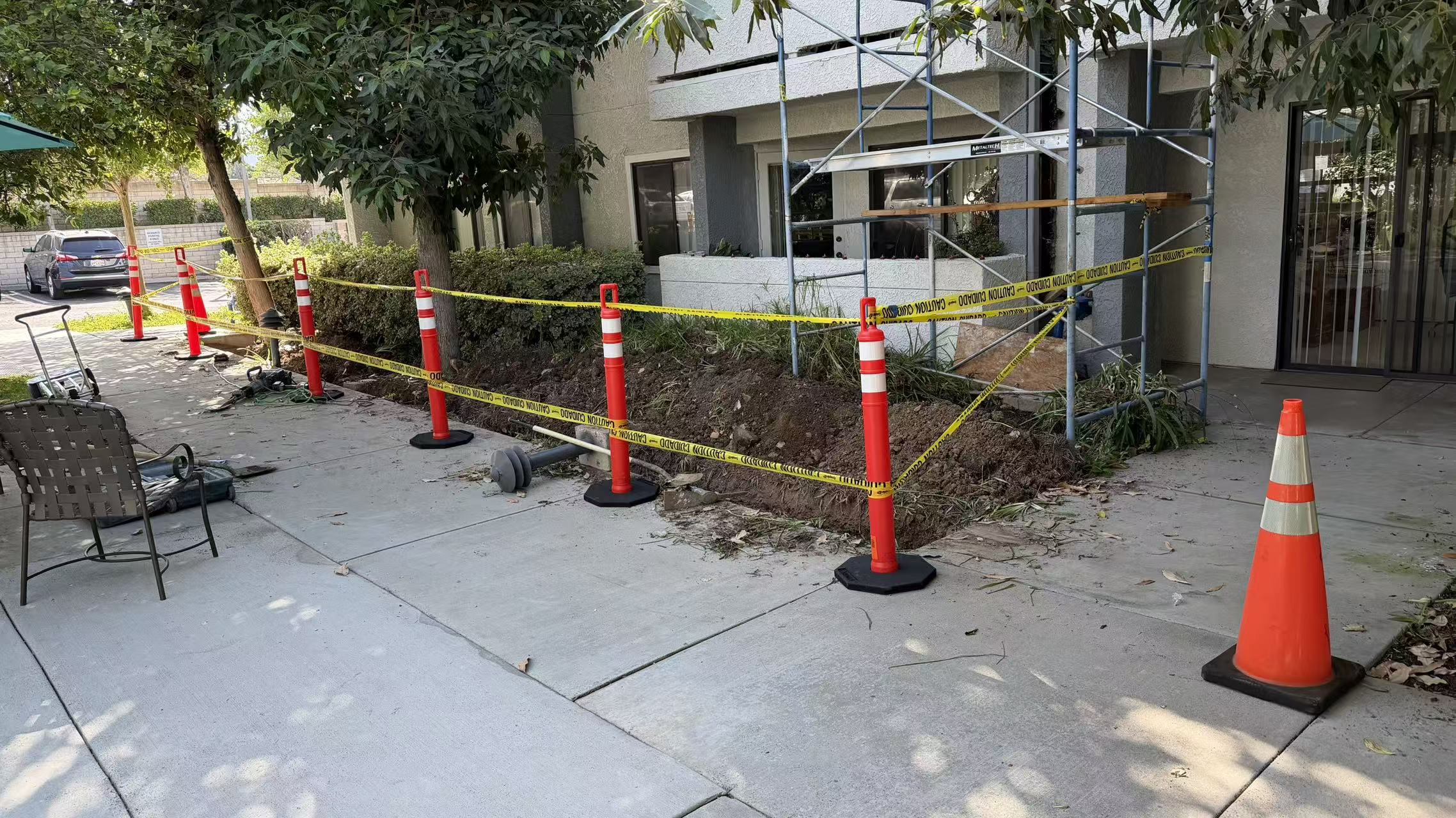 Exterior work area with warning tape and delineators