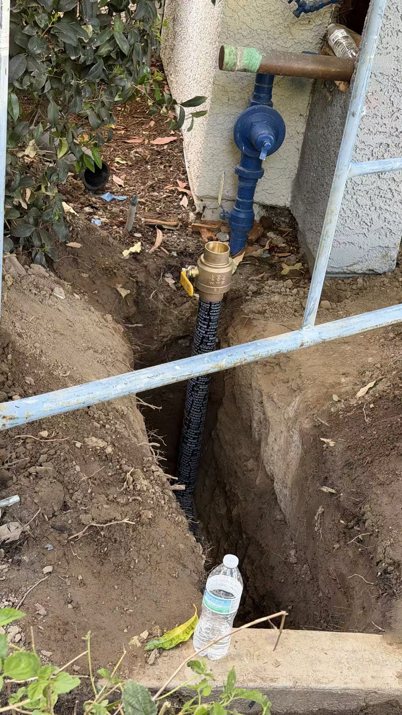 Protected riser and valve installation in progress